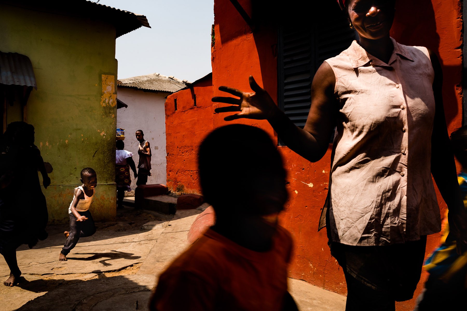 street photography, colorful images with high contrast and shadows in Ghana, Africa, by ivan Margot