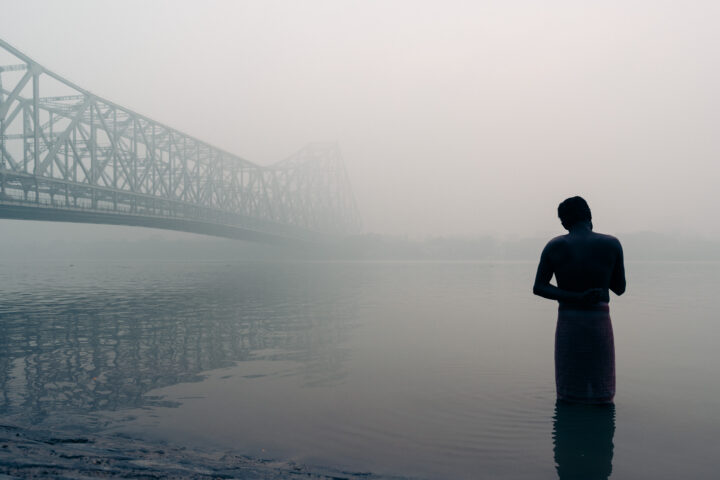 color travel photo of man bathing in kolkota, india by Frederic Mette